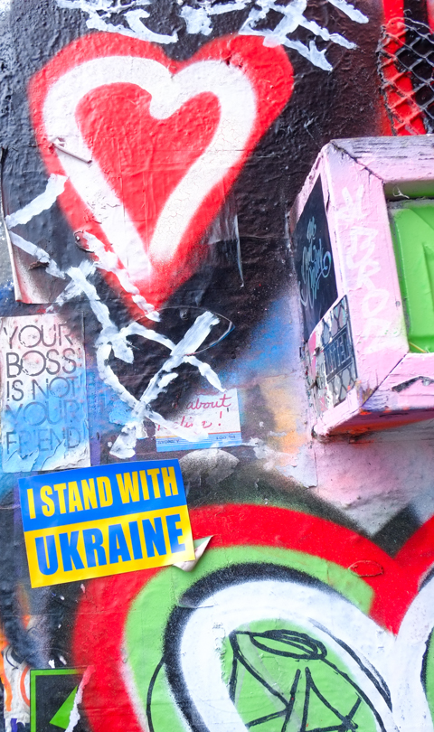 stand with ukraine yellow and blue sticker, graffiti