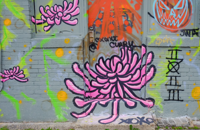 part of a large mural by coconut curry, pink flowers on grey background