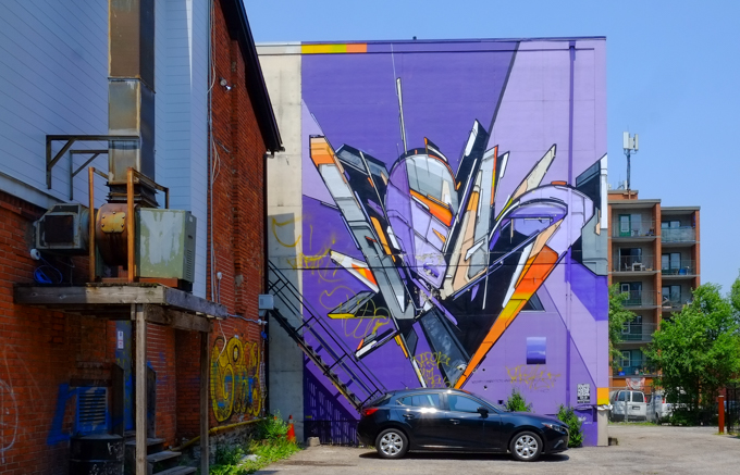 mural of graphics, lines, angles and shapes on a bright purple background, by Mediah