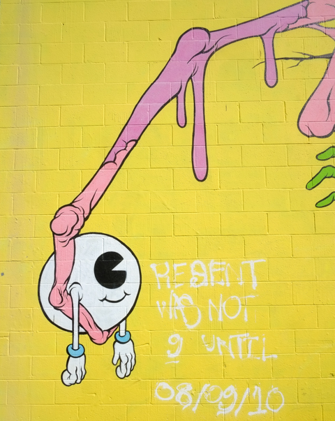 a long scrawny arm catches a smiling eyeball