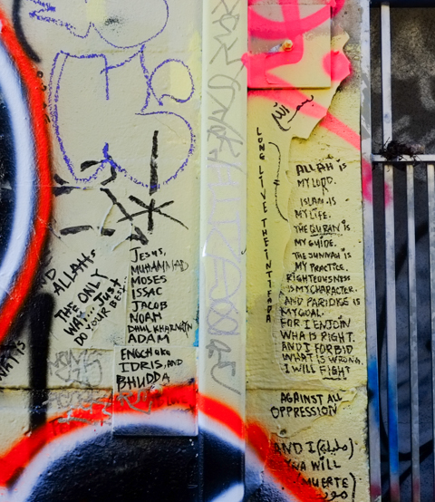 lots of words written in black marker, among other graffiti