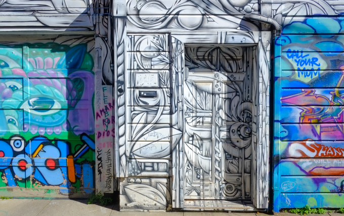 door covered with graffiti street art mural