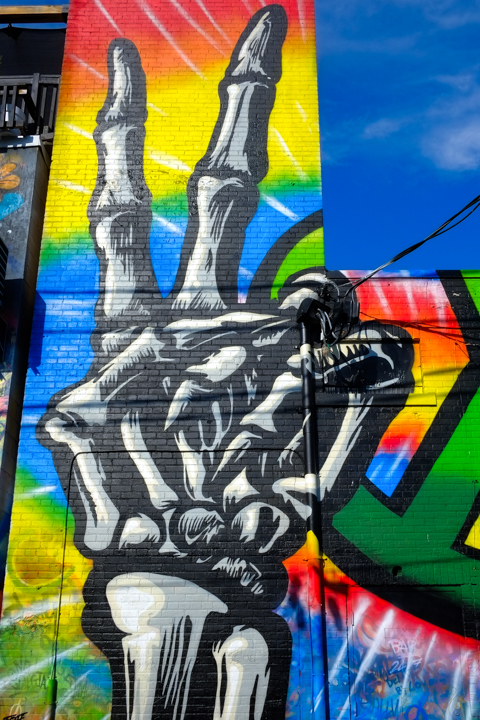 hand, with just bones, making a peace symbol, with two fingers in V shape