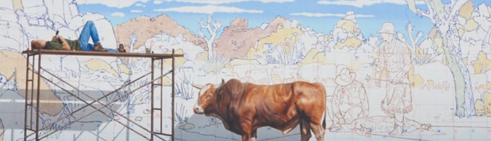 mural, cow standing in front of a wall that is partially painted, man sleeping on scaffolding that is against the wall,