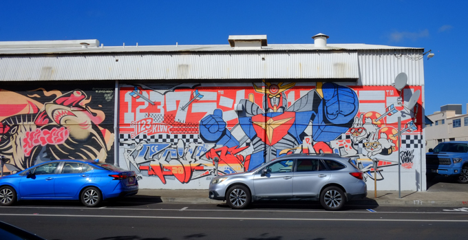 street art mural in Honolulu plus reflections in a car window of 