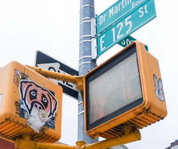 at a harlem intersection, slaps on traffic lights