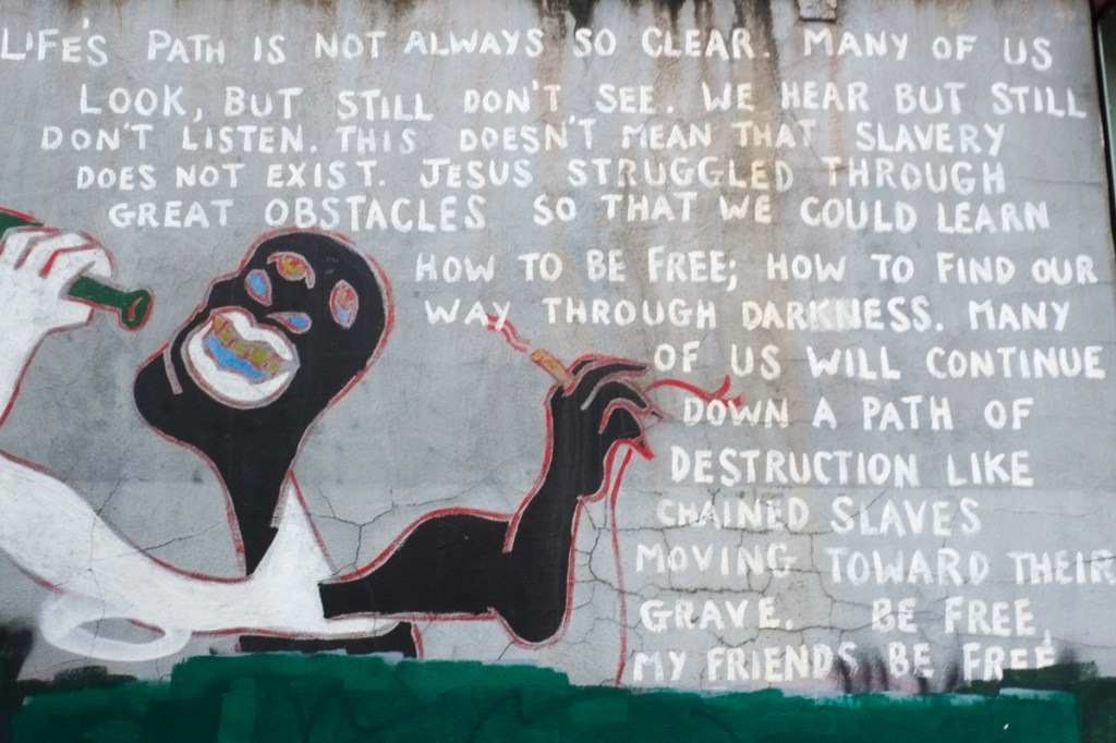 mural in grey tones, a man, and lots of text