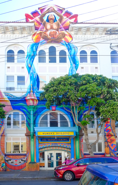 front of the womens building in san francisco, bare breasted woman at top center