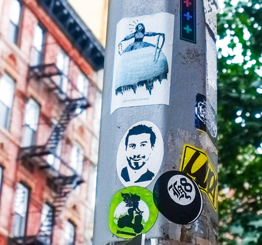 graffiti stickers on a pole
