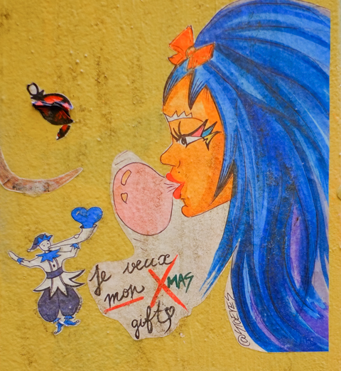 small Christmas themed paste ups on a yellow wall in Melbourne, Baptist Place,  a woman in profile by stoeyes, with long blue hair and blowing a bubble gum bubble, ith cursive words, je veux mon gift, also a wall lilo figure