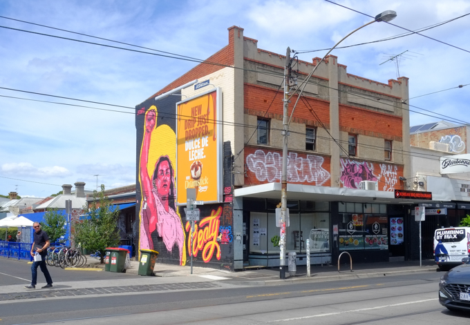 street art mural on the side of an old two storey building on Sydney Road in Brunswick