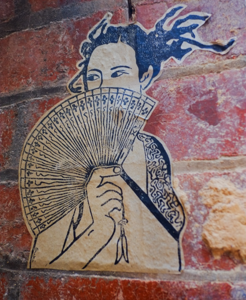 urban art in AC DC lane in Melbourne, Asian looking woman with a fan