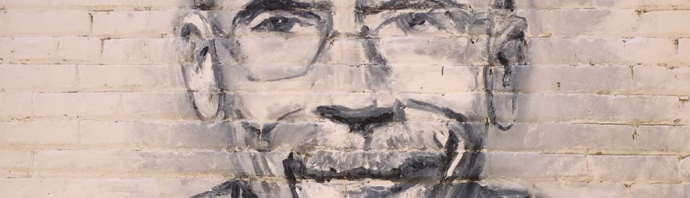 part of a black and white street art portrait of a man, just his face shown here