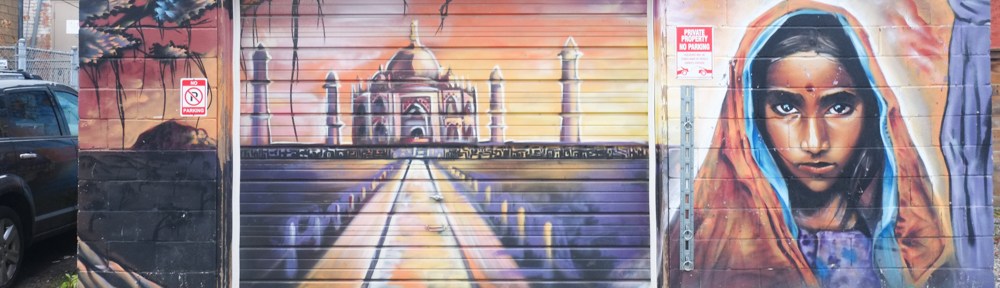 mural, portrait of a young woman, beside the Taj Mahal in India