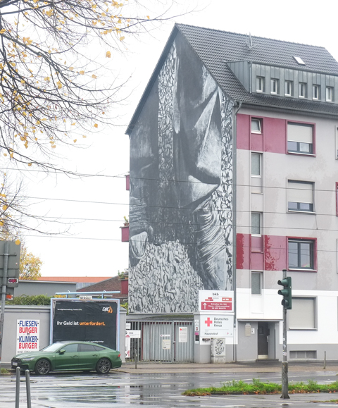 street art mural in Dusseldorf Germany, by Hendrik Beikirch, monochrome, boots and bottom of pants leg, on the side of a building