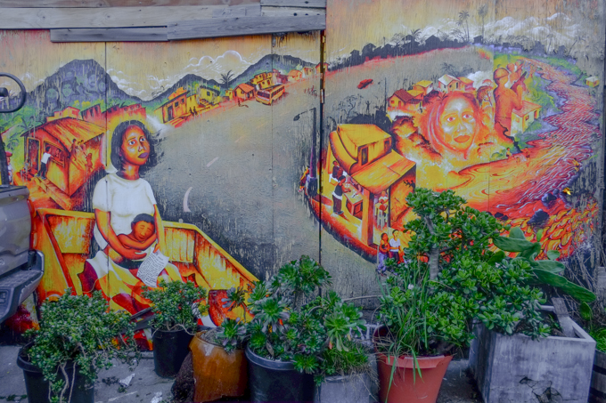 mural by Joel Bergner, mother holding a child, sitting outside, 