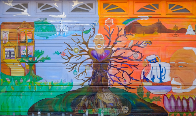 man as a tree, orange desert background on one side, blue city background with a house on the other