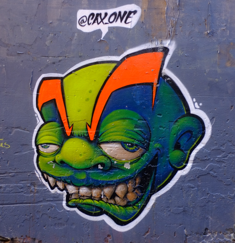 Ugly face, graffiti, big eyes, big teeth, green and blue face, by Cax One, 