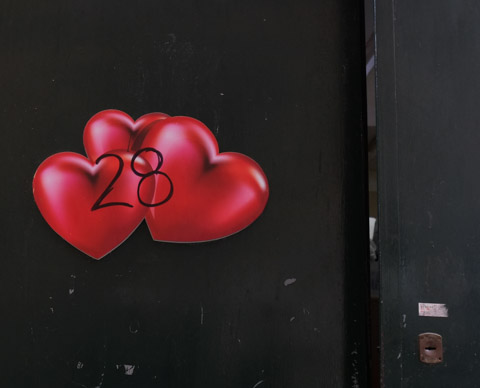 three very 3 D looking shiny red hearts, paper graffiti