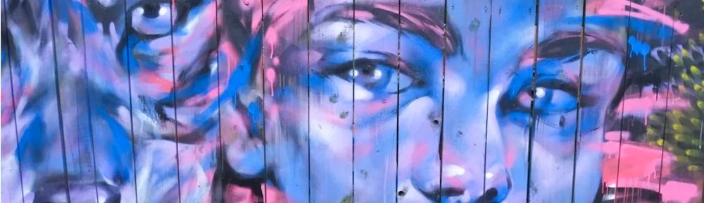 street art on wood fence, blue faces of girl and wolf