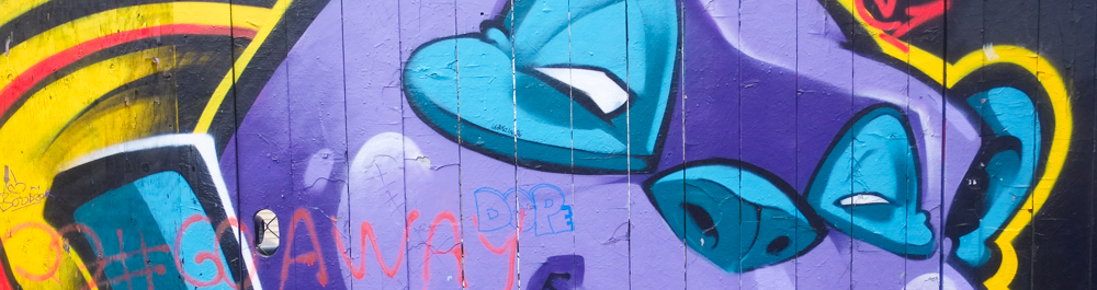 part of a mural of a purple faced character with blue around eyes