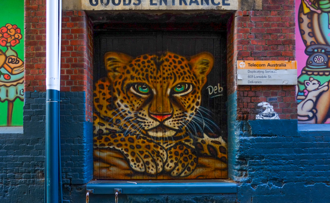 painting of a leopard by DEB sitting in a doorway