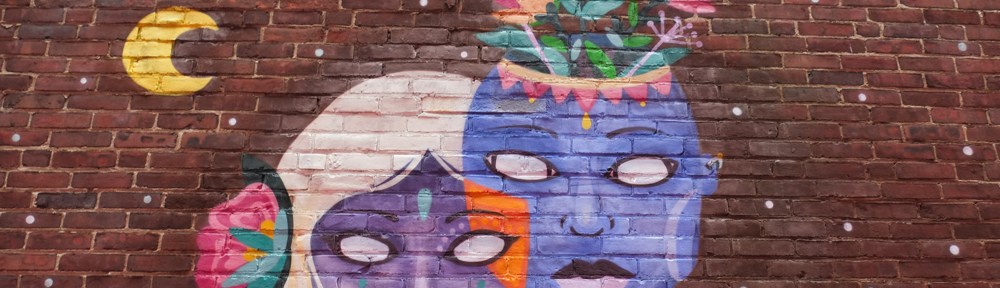 part of a larger mural on equality in Salem massachusetts, two blue faces, one male and one female, white eyes,