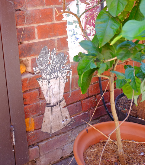 graffiti in Rankins Lane, Melbourne, paste ups, espresso coffee maker being used as a planter, on a brick wall behind a real potted plant