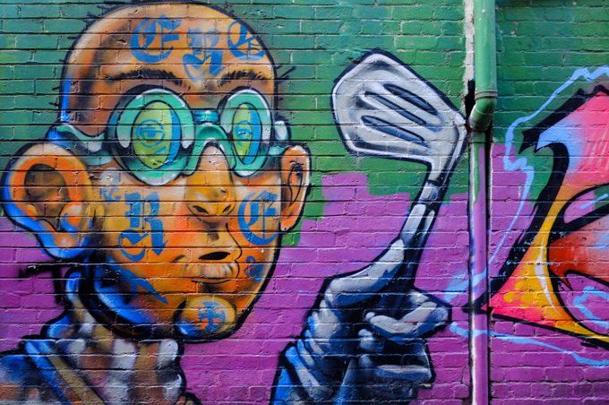 man with tattoos in his face, mural, holding a golf club in his hands 