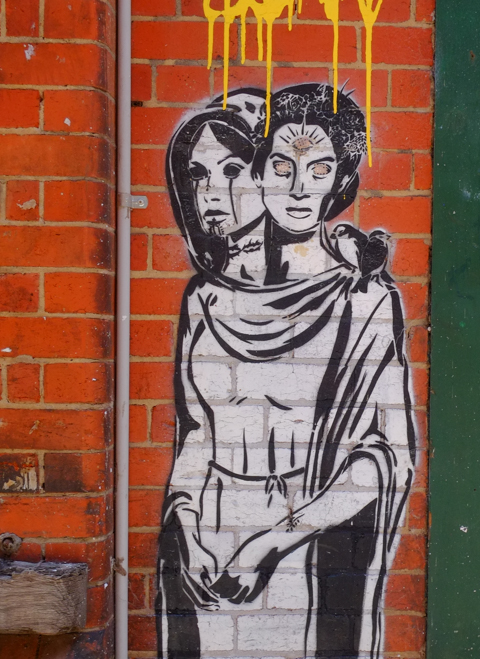graffiti in Rankins Lane, Melbourne, paste up by King of Clowder of a woman with two heads