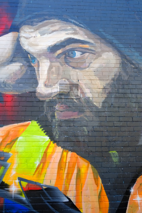 street art painting, portrait, one workman with beards and mustaches, yellow and orange high viz vests, black wool hats