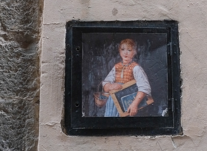 graffiti paasste up of modified famous painting of a schoolgirl