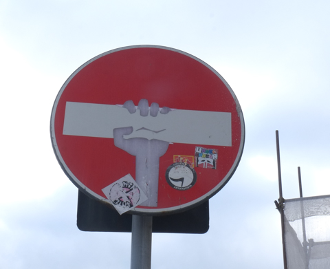 modified traffic sign, graffiti, by Clet Abraham, in Florence,