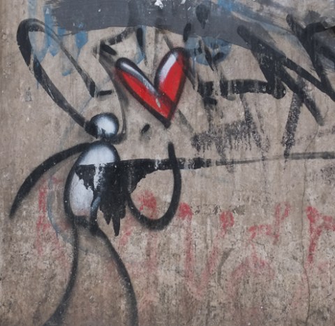 exit enter, the artist, graffiti of a small white and black feature-less figure with a red heart