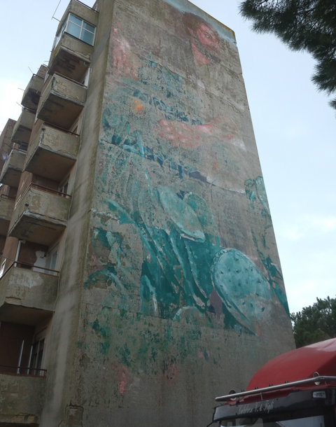 faded mural by Fintan Magee, title is the gardener