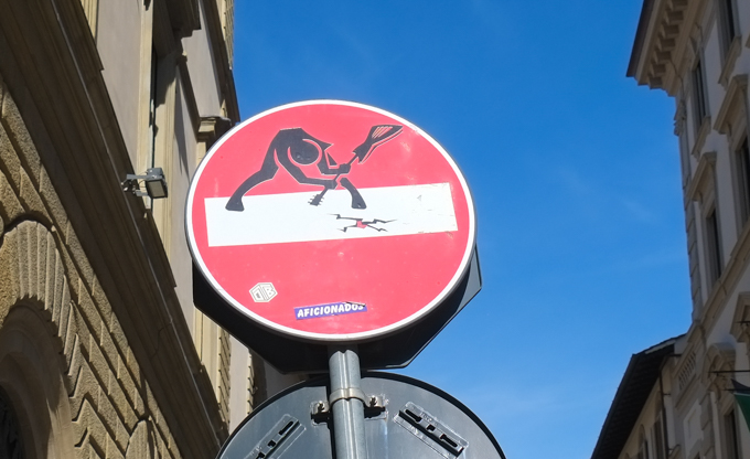 modified traffic sign, graffiti, by Clet Abraham, in Florence, smashing guitar