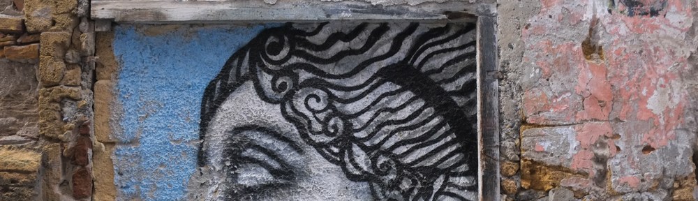 eyes and forehead of a woman's street art portrait, classical, on an old stone wall