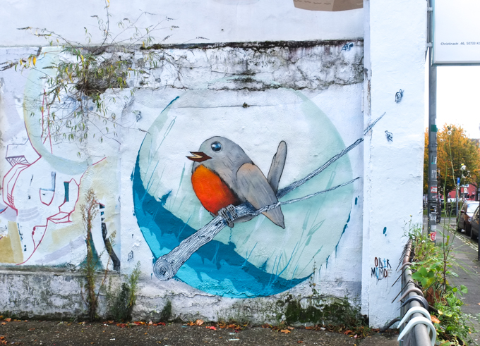  mural by artist Okik Momoe of a little bird on a branch.