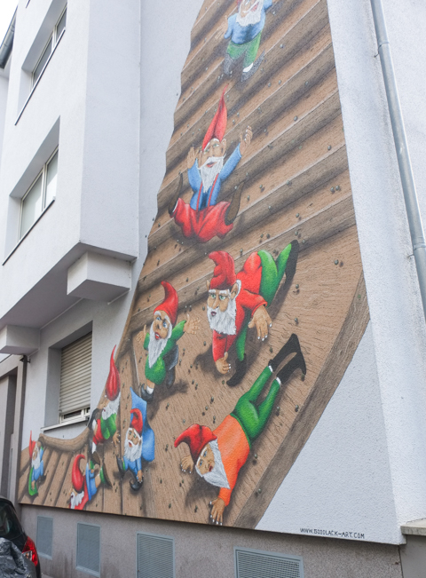 little gnomes in pointy red caps in a mural by Goodlack Arts