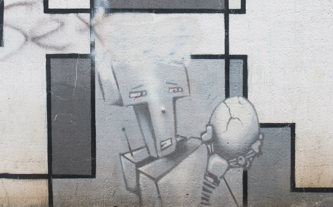 monochrome mural that is part puzzle pieces and part little figures. Ben Mathis was responsible for creating the 'grid', while MaJo Brothers painted the figures such as this robot holding a cracked egg