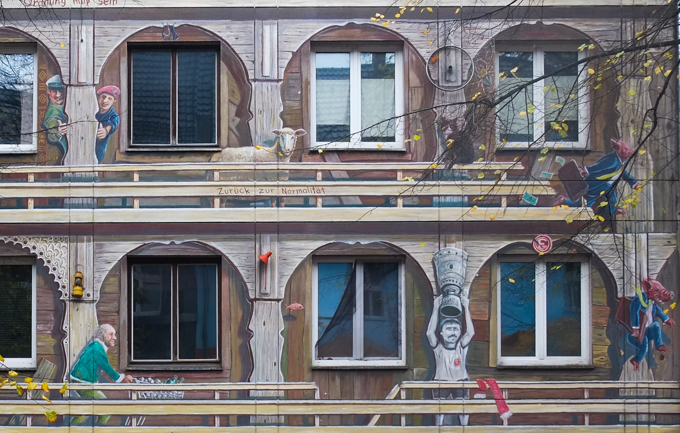 mural in "trompe-l'œil style" - it's painted to look like a wooden balcony structure.