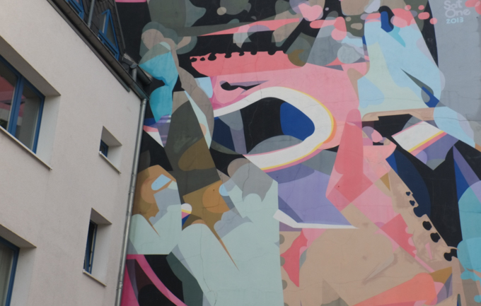 A closer look at part of mural by Sat One on a gable in Nippes Cologne