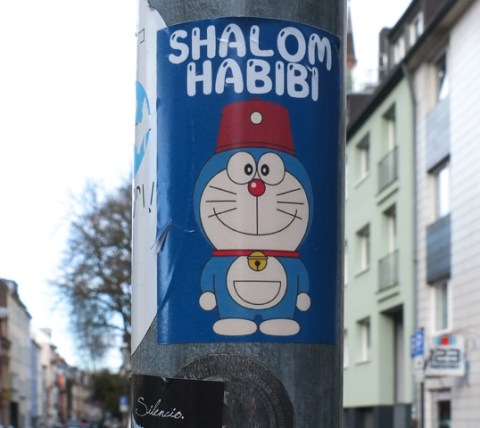 sticker with a cat wearing a Turkish red hat, with text Shalom Habibi
