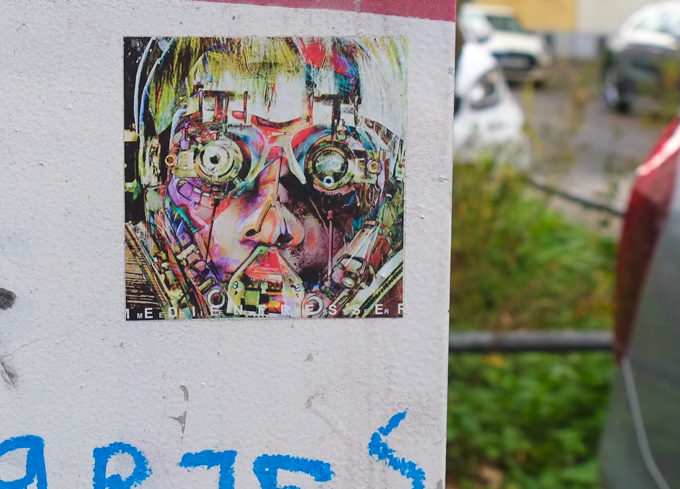 graffiti, of a face but with mechanical or robotic parts