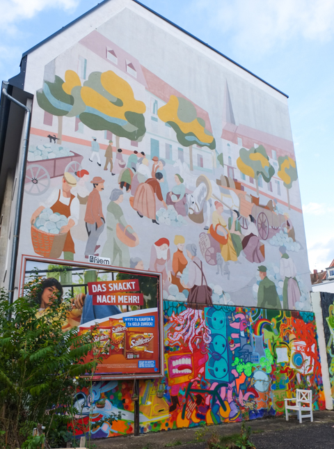 gable mural, large mural in Nippes depicting daily life, making things, hauling, selling