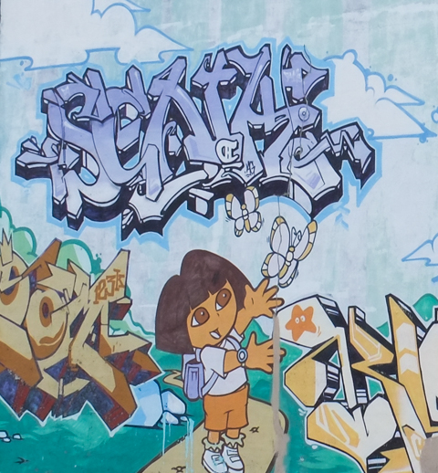 mural of children's television character, Dora the explorer chasing butterflies