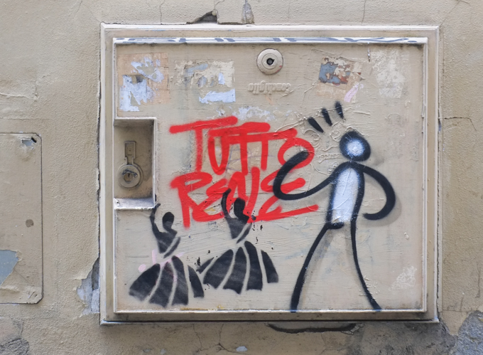 graffiti in Florence Italy by artist Exitenter, black drawing of a person with two dancing ladies stencils