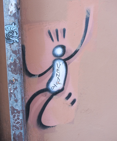 graffiti in Florence Italy by artist Exitenter, black drawing of a person trying to climb a metal pole