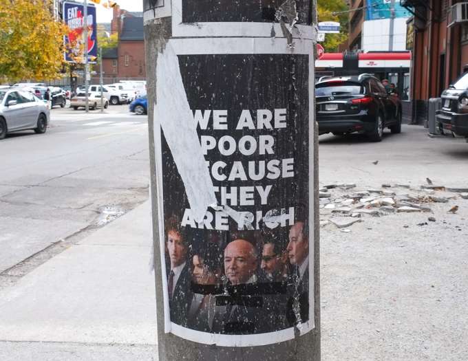 poster with pictures of Mark Zuckerberg, Jeff Bezos, and Elon Musk, with words, we are poor because they are rich