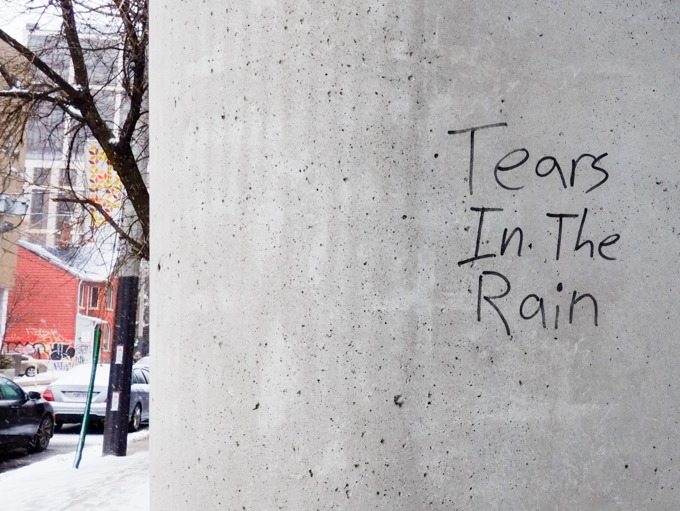 graffiti, black marker on grey concrete, that says tears in the rain